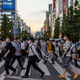 A crowd of people cross the street in Akihabara.